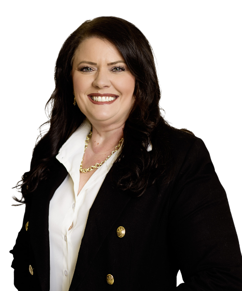 A consultant with long dark hair wearing a black blazer with gold buttons, a white shirt, a gold necklace, and gold earrings, smiling at the camera against a plain background.